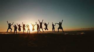 Participants celebrating together at sunset